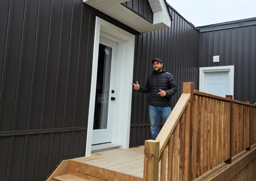 a man standing outside a house